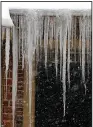  ?? (Arkansas Democrat-Gazette/ Thomas Metthe) ?? As snow picks up Wednesday, icicles hang from a house in the Hillcrest neighborho­od of Little Rock.