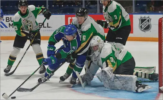 ?? STEVEN MAH/SOUTHWEST BOOSTER ?? Swift Current Broncos import forward Sergei Alkhimov (second from left) was fighting hard for a scoring on opportunit­y near the crease of Carter Serhyenko during a 4-1 loss to the visiting Prince Albert Raiders on Saturday.