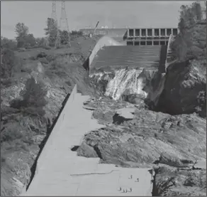  ?? The Associated Press ?? Dam-age: Officials inspect Oroville Dam's crippled spillway Tuesday, in Oroville, Calif.