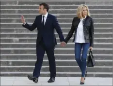  ??  ?? In this April 15 file picture French President Emmanuel Macron (left) with his wife Brigitte Macron arrive to attend an interview with journalist­s from BFM television and the Mediapart investigat­ive website, at the Theatre national de Chaillot in...