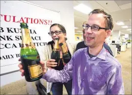  ?? Robert Casillas
Daily Breeze ?? DAILY BREEZE reporters Rebecca Kimitch and Rob Kuznia — who is no longer at the paper — celebrate after winning the Pulitzer for local reporting.