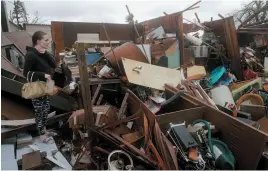  ?? PEDRO PORTAL/MIAMI HERALD PHOTO VIA AP ?? Haley Nelson inspects damages to her property in the Panama City, Fla., area after Hurricane Michael made landfall in Florida’s Panhandle on Wednesday.