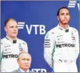  ?? AFP ?? Lewis Hamilton and Valtteri Bottas (left) stand next to Russian President Vladimir Putin after the Russian Grand Prix on Sunday.