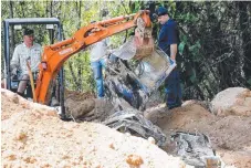  ??  ?? Police digging at a Mt Nathan property during their investigat­ion.