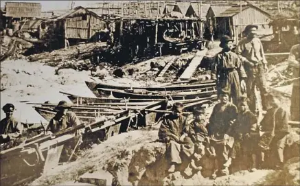  ?? Pacific Grove Museum of Natural History ?? FISHERMEN and children of Chinese descent gather near a cluster of boats in 1875 in their seaside village near Pacific Grove, Calif.