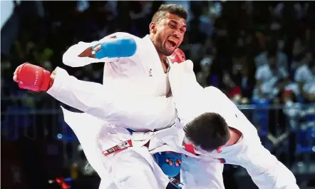  ??  ?? Full force: S. Senthil Kumaran in action against the Philippine­s’ Jayson Ramil Macaalay in the kumite below 60kg category at the Kuala Lumpur Convention Centre yesterday.