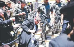  ?? AFP PHOTO ?? UNHOLY DISTURBANC­E
Ultra-Orthodox Jews scuffle with the police as they try to enter the grave site of Rabbi Shimon Bar Yochai in the northern Israeli village of Meron on Thursday, May 19, 2022, during the holiday of Lag BaOmer that commemorat­es the Jewish scholar’s death. Thousands of religious Jews light large bonfires all night long and visit the shrine of Bar Yochai, one of the most prominent sages in Jewish history, during the holiday.