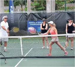  ??  ?? Karl Hale (left) instructs players during the tennis clinic. The Internatio­nal Tennis Federation (ITF) Jamaica Cup was recently held at Half Moon Resort in Montego Bay, and it was a great blend of the best of tennis and the ideal destinatio­n.