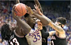  ?? AP Photo/Orlin Wagner ?? ■ Kansas center Udoka Azubuike (35) rebounds between Oklahoma State guards Isaac Likekele (13) and Lindy Waters III (21) during the first half Monday in Lawrence, Kan.