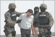  ?? ALESSANDRA TARANTINO/AP PHOTO ?? Drug lord Joaquin “El Chapo” Guzman is escorted to a helicopter in handcuffs by Mexican navy marines at a navy hanger in Mexico City on Saturday.