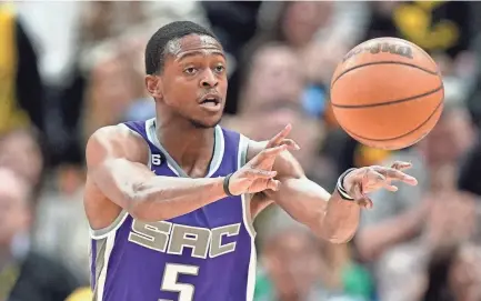  ?? RICK BOWMER/AP ?? Sacramento Kings guard De’aaron Fox (5) passes the ball in the first half of a game against the Utah Jazz on Monday in Salt Lake City. Fox is averaging 25.4 points per game this season.