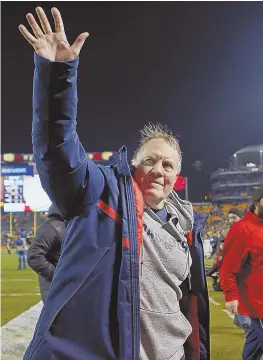  ?? STAFF PHOTO BY NANCY LANE ?? HAPPY DAZE: Bill Belichick celebrates as he leaves the field after the Pats’ big win yesterday in Pittsburgh.