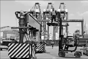  ?? XINHUA ?? Employees work on gantry cranes at a container yard operated by China COSCO Shipping Corp Ltd at the port of Piraeus in Greece. The company is planning to take full advantage of the opportunit­ies that are likely to arise from the Belt and Road...