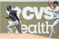  ?? GERALD HERBERT/AP ?? The New York Yankees’ Jake Bauers is caught in a rundown as he tries to elude Boston Red Sox second baseman Christian Arroyo in the third inning of a spring training baseball game in Fort Myers, Fla. on March 12.