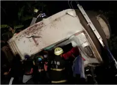  ??  ?? This CNA handout picture shows rescue workers checking the derailed train. — AFP photo