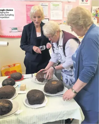  ??  ?? Tough choice Judging the clootie dumpling competitio­n