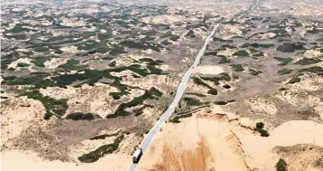  ??  ?? An oil tanker drives through desertifie­d land in Hengshan county, northwest China’s Shaanxi province. China stocks dipped yesterday as fears of fresh property cooling measures and broader monetary policy tightening hit shares of developers. — Reuters...