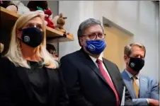  ?? AP PHOTO/BRYNN ANDERSON ?? U.S. Attorney General William Barr, center, Georgia Gov. Brian Kemp, right and a Georgia Center for Child Advocacy staff member listen during a tour on Monday.