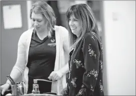  ?? [BROOKE LAVALLEY/DISPATCH] ?? Chef Jessica Levy, left, and Executive Director Paula Haines talk with employees of Freedom a la Cart.