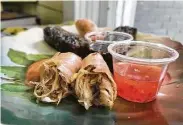  ??  ?? Spring rolls come with a sweet red chile and garlic dip and awaken the taste buds.