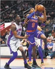  ?? Carlos Osorio / Associated Press ?? Knicks guard RJ Barrett ( 9) makes a layup as the Pistons’s Tony Snell defends during the first half on Saturday in Detroit.