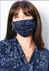  ??  ?? Tory blue: Sam Cameron matches a mask to one of her own fashion designs