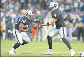  ?? D. ROSS CAMERON — THE ASSOCIATED PRESS ?? Quarterbac­k Derek Carr, right, and running back Doug Martin should be locked in as members of the Raiders’ 53-man roster when Saturday’s deadline arrives.