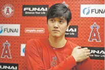  ?? CHRIS CARLSON/ASSOCIATED PRESS ?? The Angels’ Shohei Ohtani talks to the media Wednesday at their spring training facility in Tempe, Ariz. The AL Rookie of the Year is recovering from Tommy John surgery.