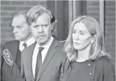  ?? — AFP file photo ?? Huffman, escorted by husband Macy, exits the John Joseph Moakley United States Courthouse in Boston, last month.