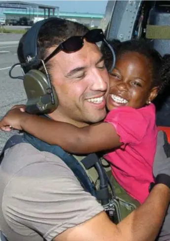  ??  ?? Known only as Katrina Girl or Katrina Kid, LaShay Brown and her beaming smile became famous when a picture of her hugging U.S. air force serviceman Michael Maroney was published by media outlets around the world.