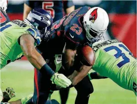  ?? [AP PHOTO] ?? Arizona Cardinals and former Oklahoma running back Adrian Peterson, center, fumbles the ball during Thursday night’s NFL game against the Seattle Seahawks in Glendale, Ariz.