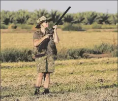  ??  ?? CINDY PONCE DE LEON, FROM HEMET, CALIF., waits patiently for doves to pass overhead while standing in a recently cut alfalfa field in the area of County 18th Street and Avenue 1E early Tuesday morning.