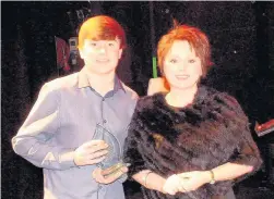  ??  ?? Jack Cox, pictured with adjudicato­r Rebecca Evans, was the winner of the 11 to 14 age category at the Dunraven Welsh Young Singer of the Year 2017