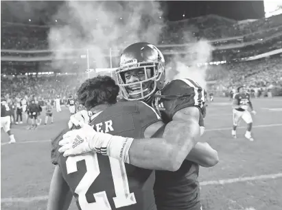  ?? THE ASSOCIATED PRESS ?? Texas A&amp;M wide receiver Kendrick Rogers, right, celebrates with Charles Oliver after the Aggies beat LSU in seven overtimes.