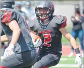  ??  ?? Redwood’s Thomas Johnson carries the ball during their game against San Marin at Redwood High on Saturday.