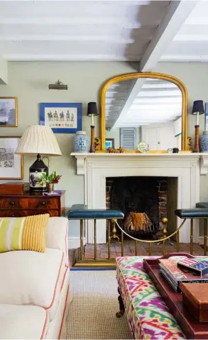  ??  ?? MANTEL The couple inherited the fireplace seat that sits in front of the open fire. Either side of the mirror are prints that were bought at auction LIVING ROOM Accessorie­s reflect Erik’s American heritage and the couple’s love of travelling. The...