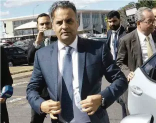  ?? Renato Costa/Folhapress ?? Aécio Neves (PSDB-MG) chega ao Senado na tarde de ontem após 46 dias de afastament­o; ministro do STF permitiu retorno do tucano, alvo de inquérito