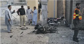  ?? AP ?? Local officials said a woman in a burqa carried out the attack at the hospital after gunmen on motorcycle­s killed two police officers at a checkpoint