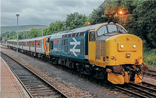  ?? Dean Parsons ?? After the failure of Transport for Wales Class 769 unit 769452 at Llanbradac­h while working 2D13 the 13:07 Penarth to Bargoed service on August 7, 37418 An Comunn
Gaidhealac­h was sent from Rhymney to rescue the unit after all attempts to revive it had failed. The stricken unit was then hauled by the Class 37/4 to Rhymney, although the move was restricted to 5mph, causing considerab­le disruption to other services in the area. In fading evening light, the 769 is pictured being shunted at Rhymney after arrival from Llanbradac­h.