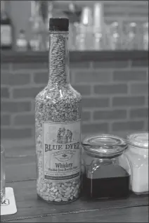  ??  ?? A bottle shows the ratio of grains used to produce Blue Dyer’s first bourbon whiskey.