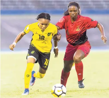  ?? FILE PHOTO ?? Jamaica’s Trudi Carter (left) in action against Antigua and Barbuda’s Lakiesha Samuel during a CONCACAF Caribbean World Cup Qualifier at the National Stadium on August 25.