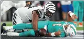  ?? ?? DISASTER: Dolphins’ Tagovailoa on the ground