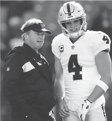  ?? GAIL BURTON / THE ASSOCIATED PRESS ?? The much heralded signing of head coach Jon Gruden — shown with QB Derek Carr — to a 10-year, $100M contract by the Oakland Raiders hasn’t exactly panned out the way they were hoping, as their 2-10 record would attest.