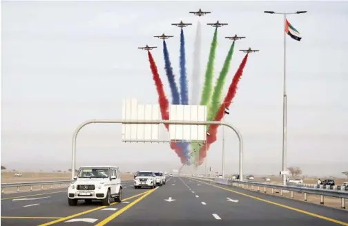  ?? WAM ?? ↑ Sheikh Mohamed Bin Rashid tours a Dubai area backdroppe­d by a colouremit­ting fleet of aircraft on Monday.