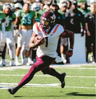  ?? VIRGINIA TECH ATHLETICS ?? Virginia Tech quarterbac­k Kyron Drones finds running room against Marshall on Saturday in Huntington, West Virginia. Drones finished with 75 rushing yards and two touchdowns.