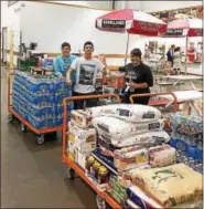  ?? SUBMITTED PHOTO ?? Quin Mastrangel­o, center, is joined by Heather Gelting and Lisa Demetrio purchasing supplies in Costco with money he made from a bake sale at The Hill School.