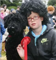  ??  ?? Eoin Medlycott and Ashe who won the dog and owner look-a-like competitio­n at the Roundwood Festival.