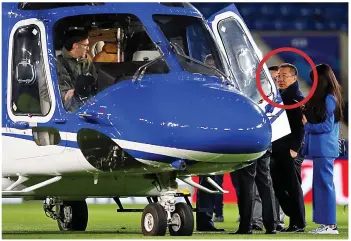  ??  ?? Flight: Mr Srivaddhan­aprabha, circled, takes a helicopter in April