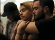  ?? ASSOCIATED PRESS ?? University of Nevada Las Vegas students Raymond Lloyd, right, and Karla Rodriguez take part in a vigil Monday in Las Vegas. A gunman on the 32nd floor of the Mandalay Bay casino hotel rained automatic weapons fire down on the crowd of over 22,000 at an...