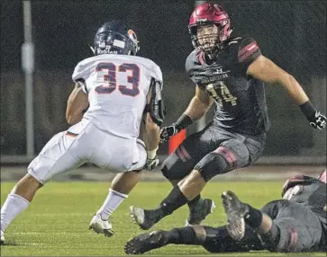  ?? Brian van der Brug Los Angeles Times ?? CHAMINDADE’S John Burton looks to cut inside to avoid Oaks Christian defensive player Josh Calvert.